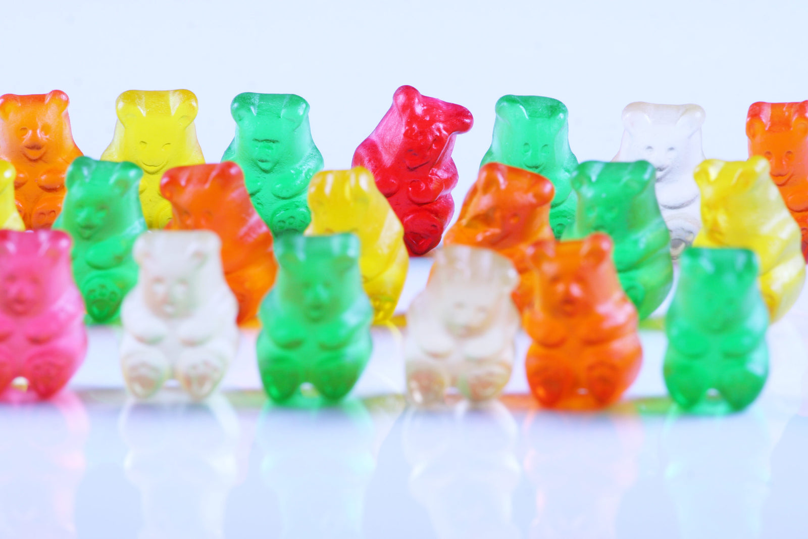 Colorful gummy bears lined up in rows to illustrate Are gummy vitamins bad for you?