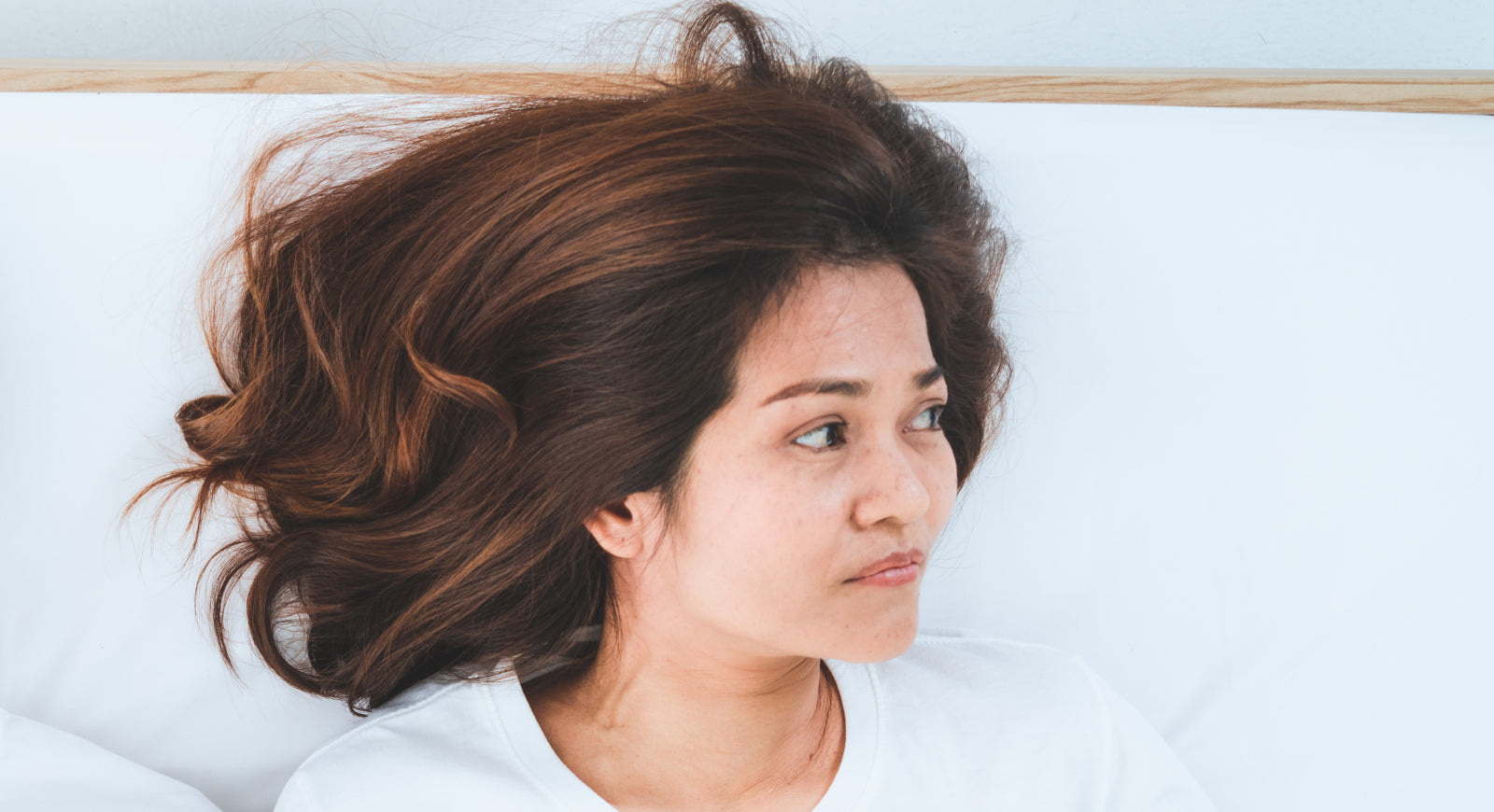 Frustrated woman lying down in bed to help illustrate Chemical Imbalance After Gastric Bypass