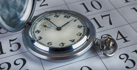 A pocket watch on an open calendar to illustrate How quickly can I get bariatric surgery