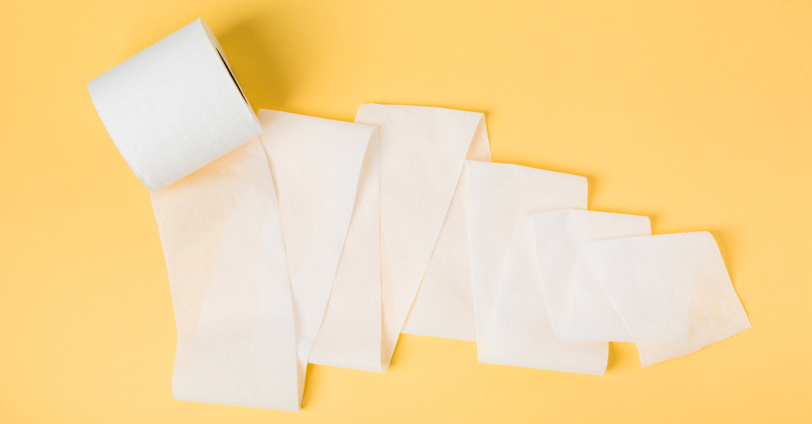 A roll of toilet paper partially unrolled on a yellow background to illustrate Why Do I Have Loose Stool After Gastric Sleeve