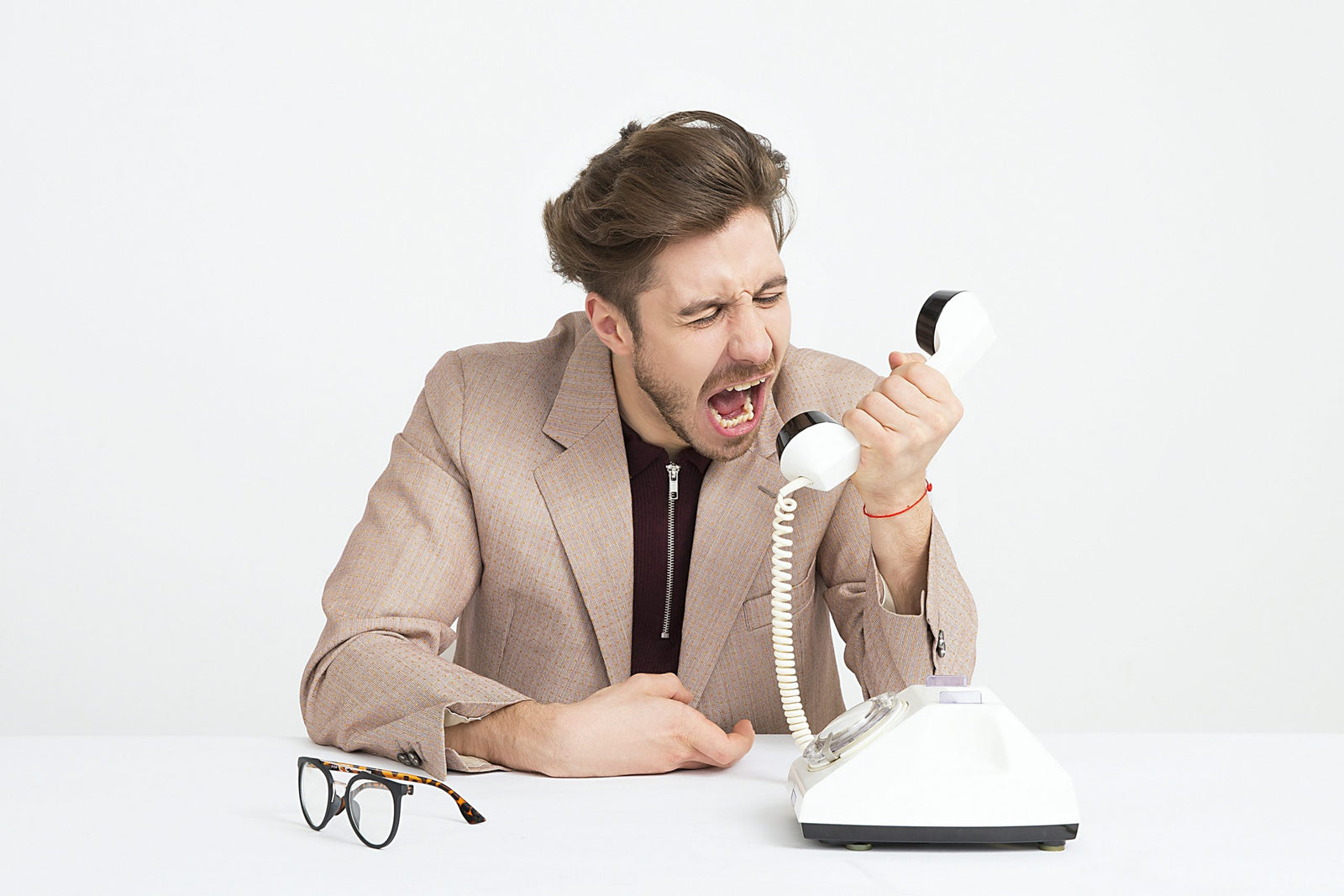 Man yelling into a phone to show anger after gastric sleeve.