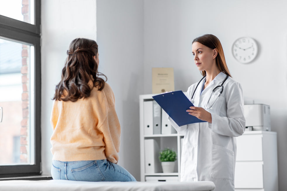 A doctor speaking with her patient in a hospital room discussing Bariatric Surgery vs. Non-Surgical Weight Loss Methods and What are Weight-Related Comorbidities