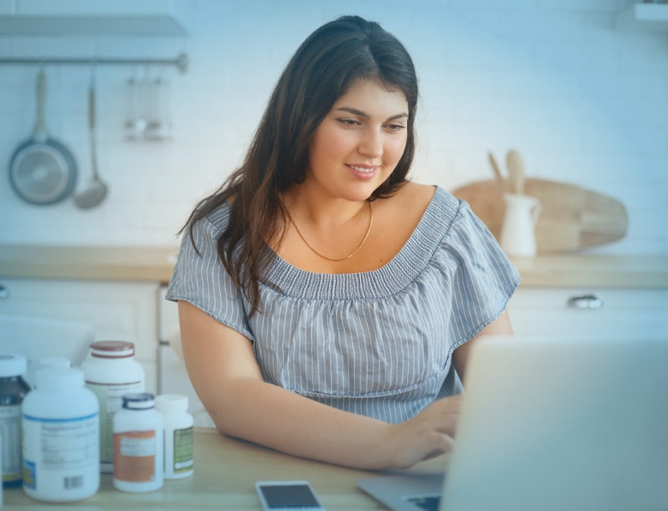 A woman researching weight loss surgery online to illustrate how to prepare for bariatric surgery.