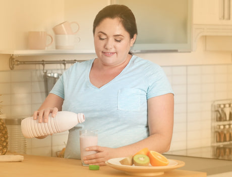 A woman pouring a liquid into a glass in her kitchen to help illustrate can I eat the night before gastric sleeve surgery and Bariatric Surgery vs. Dieting|Surgeons performing bariatric surgery to help illustrate Bariatric Surgery vs. Dieting