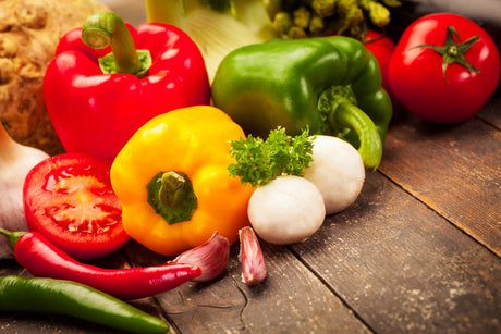 Colorful vegetables over old wooden table