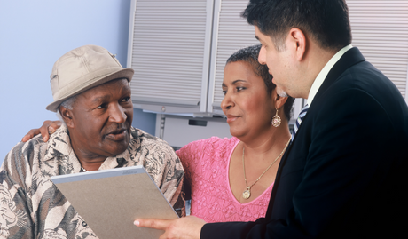 An older couple discussing health issues with their doctor in a hospital room to illustrate What are Weight-Related Comorbidities